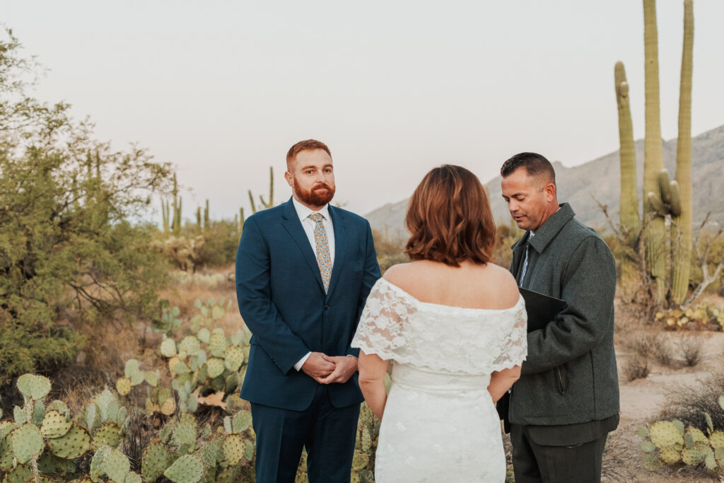 Couple exchanging vows beneath rare crested saguaro Sabino Canyon sunrise