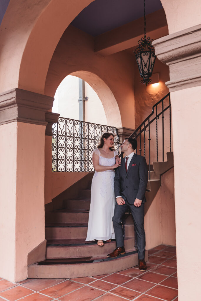 Bride and groom standing together on the courthouse stairs for a Tucson wedding photography session
