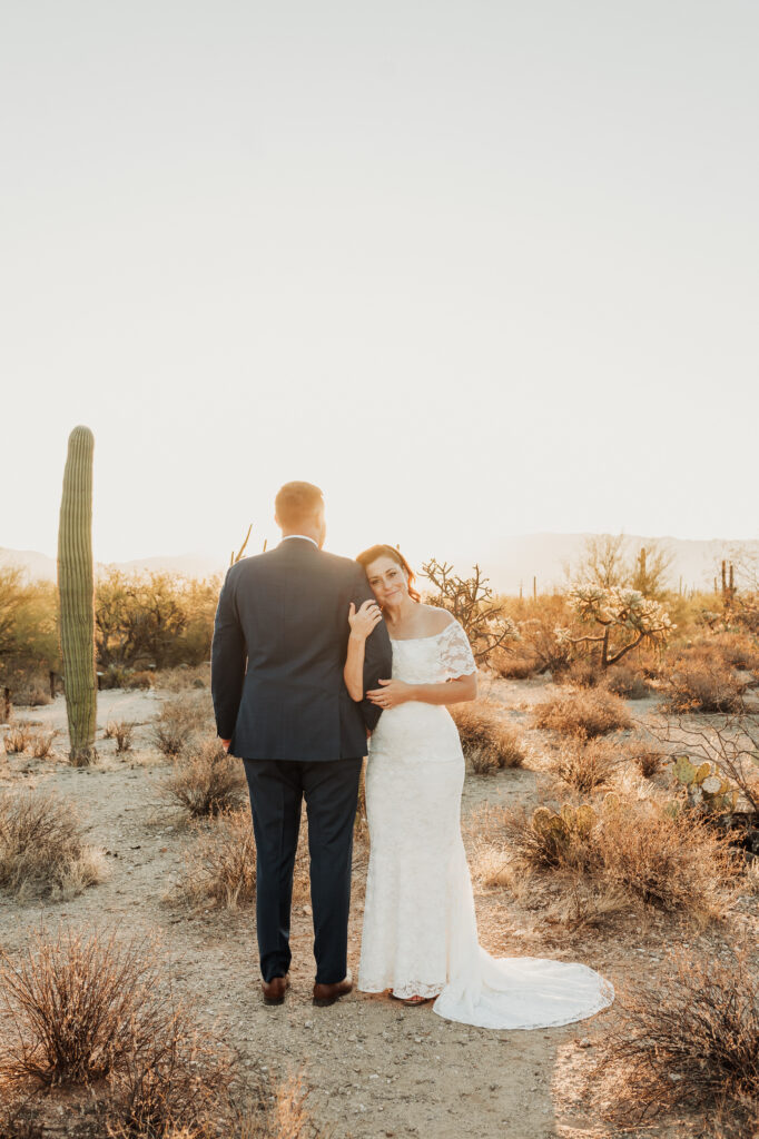 Bride and groom sunrise portraits Sabino Canyon with Catalina Mountains backdrop