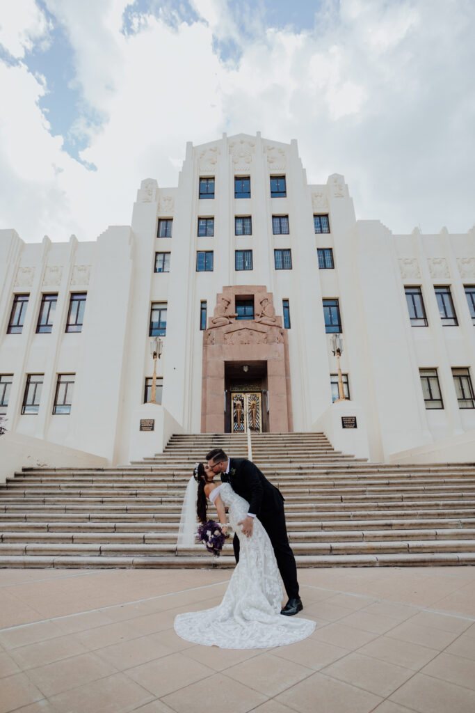 bride and groom kiss in front of courthouse in bisbee arizona