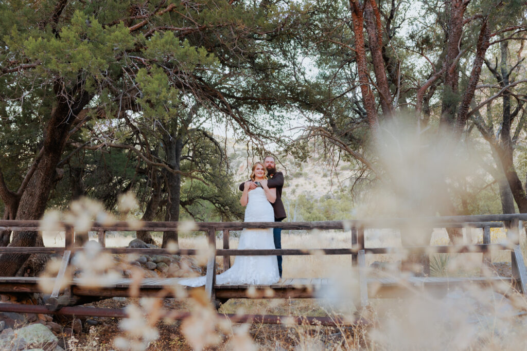 bride and groom on bridge at the historic faraway ranch at the chiricahua mountains